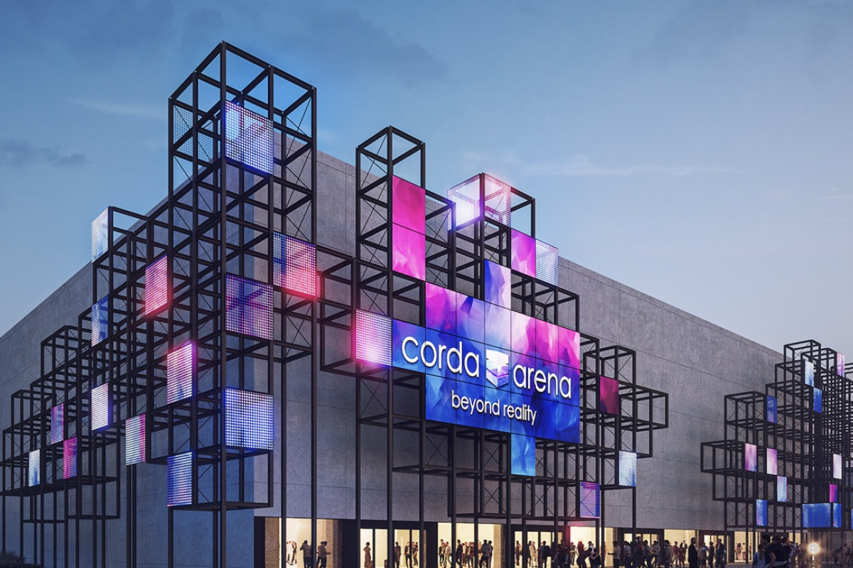 Exterior of Corda Arena at dusk with colorful LED cube frames and people gathered at the entrance.